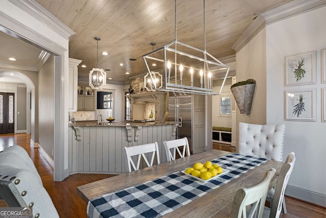 dining area with ornamental molding, dark hardwood / wood-style floors, sink, and wood ceiling