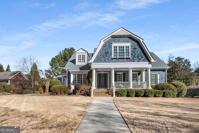 view of front facade with a front lawn and covered porch