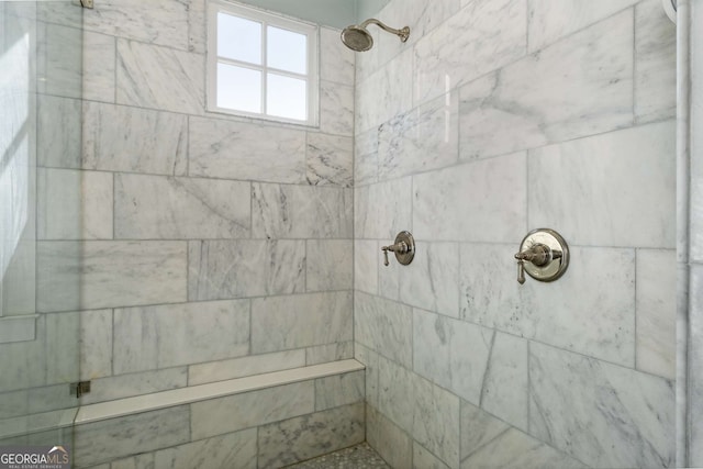 bathroom with a tile shower