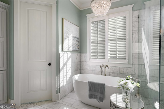 bathroom with ornamental molding, a washtub, and an inviting chandelier