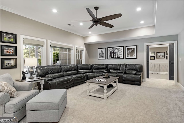 living room with light carpet, crown molding, and ceiling fan