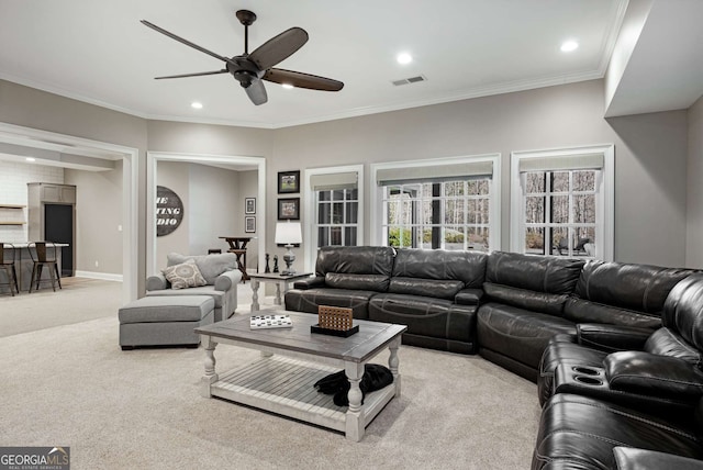 living room with ornamental molding, light colored carpet, and ceiling fan