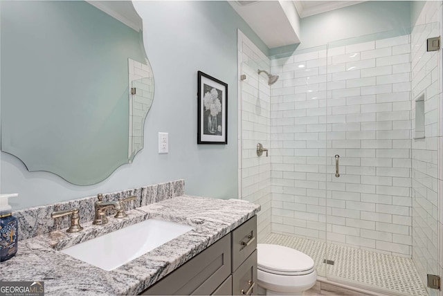 bathroom with an enclosed shower, crown molding, vanity, and toilet