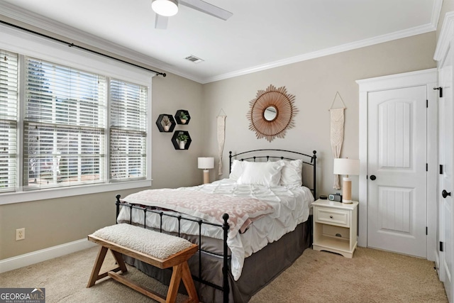 carpeted bedroom featuring ornamental molding and ceiling fan