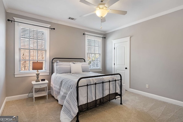 carpeted bedroom featuring ornamental molding and ceiling fan