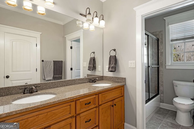 full bathroom featuring tile patterned floors, toilet, crown molding, shower / bath combination with glass door, and vanity