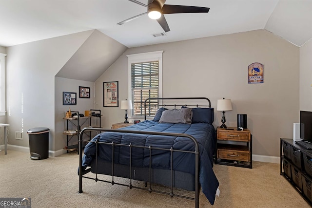 bedroom with ceiling fan, lofted ceiling, and light carpet