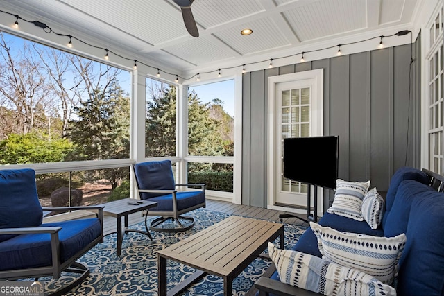 sunroom / solarium with ceiling fan and track lighting