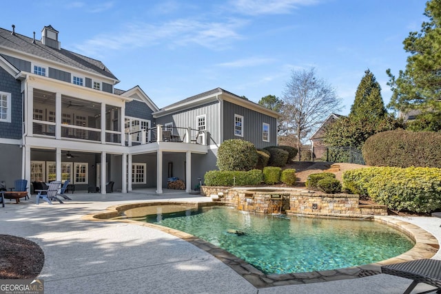 view of pool with a sunroom, a patio, and ceiling fan