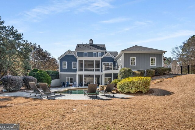 back of property featuring a balcony and a patio area