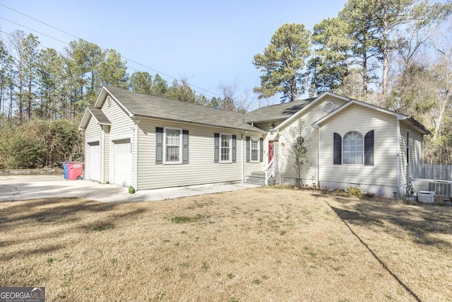 single story home featuring a garage and a front yard