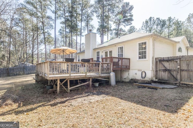 rear view of house with a wooden deck