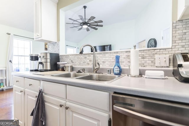 kitchen with sink, white cabinetry, vaulted ceiling, dishwasher, and ceiling fan