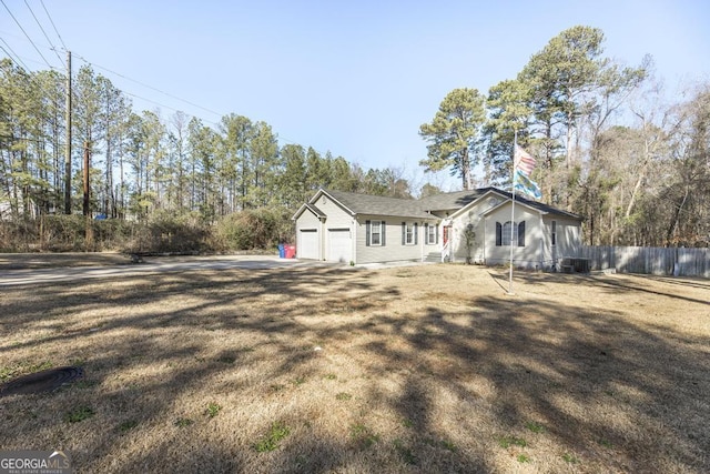 view of front of home with a garage and a front lawn