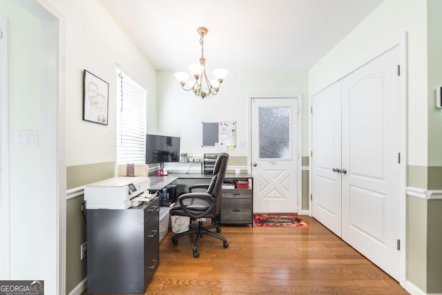 office space with wood-type flooring and a chandelier