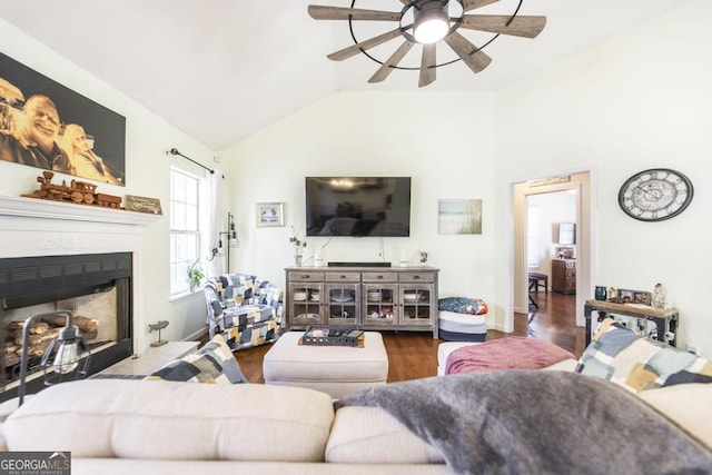 living room with hardwood / wood-style flooring, vaulted ceiling, and ceiling fan