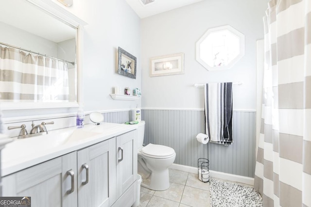 bathroom featuring vanity, toilet, and tile patterned flooring