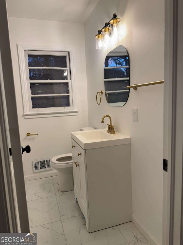 bathroom with vanity and toilet