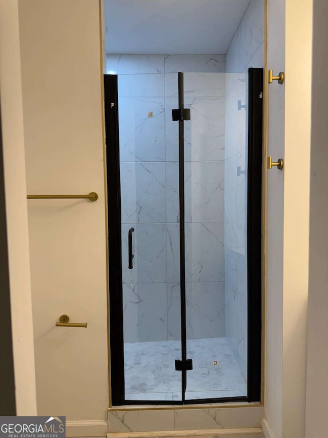 bathroom with a shower with shower door