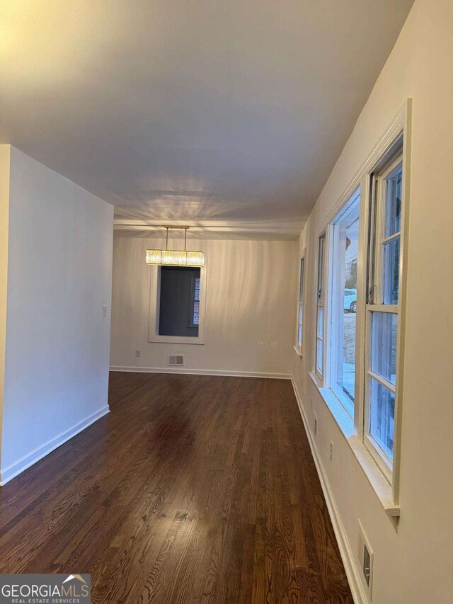 unfurnished room featuring dark hardwood / wood-style flooring