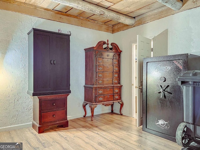 misc room with beamed ceiling, wooden ceiling, and light hardwood / wood-style floors