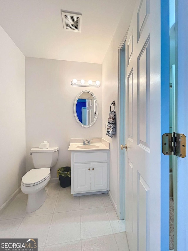 bathroom with vanity, tile patterned floors, and toilet