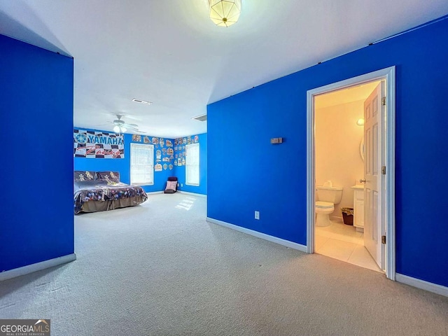 unfurnished bedroom featuring ensuite bath and carpet flooring