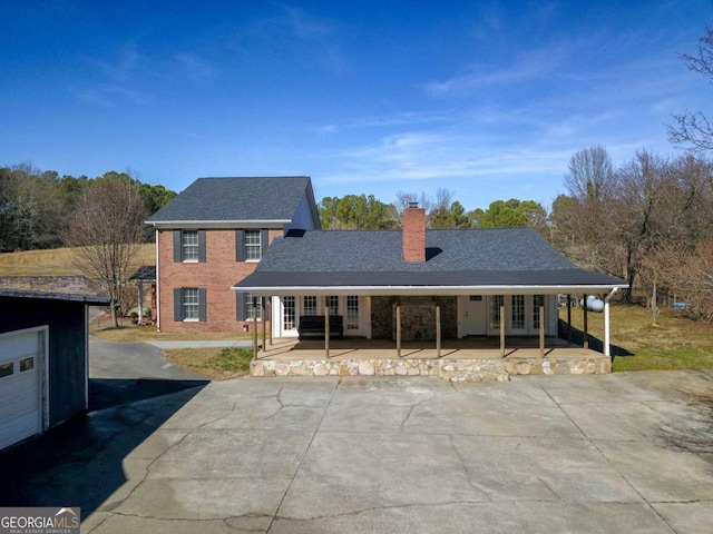 view of front facade with a garage and covered porch