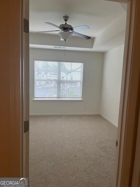 empty room with carpet and ceiling fan