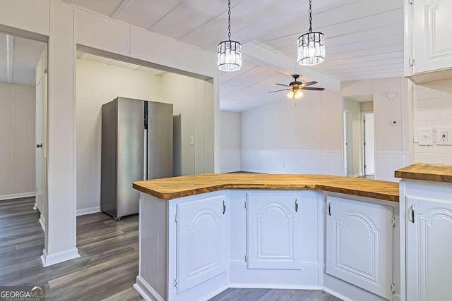 kitchen with pendant lighting, ceiling fan, white cabinetry, dark hardwood / wood-style floors, and wood counters