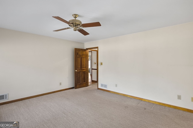 unfurnished room with light carpet, a ceiling fan, visible vents, and baseboards