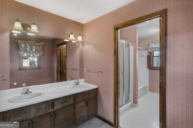 full bathroom featuring a bath, wallpapered walls, a sink, and a stall shower