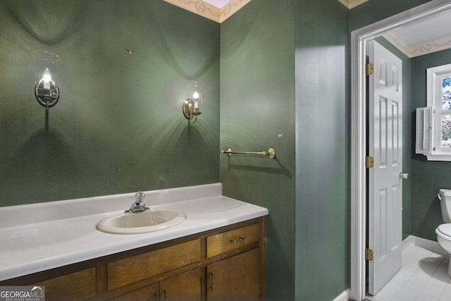 bathroom with toilet, a skylight, tile patterned flooring, and vanity