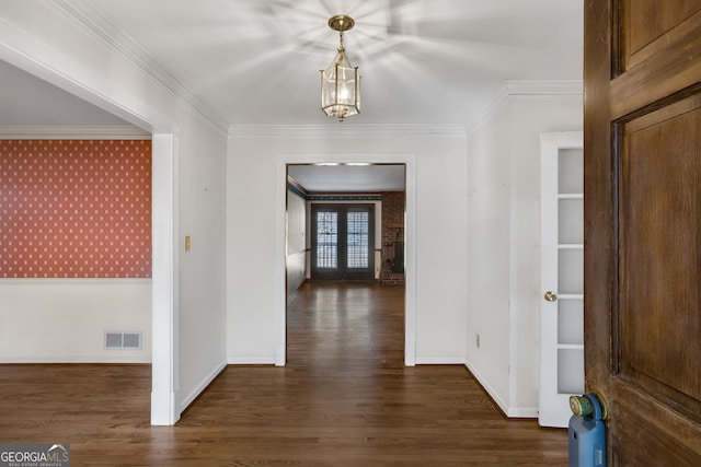 hallway with visible vents, ornamental molding, dark wood finished floors, and french doors