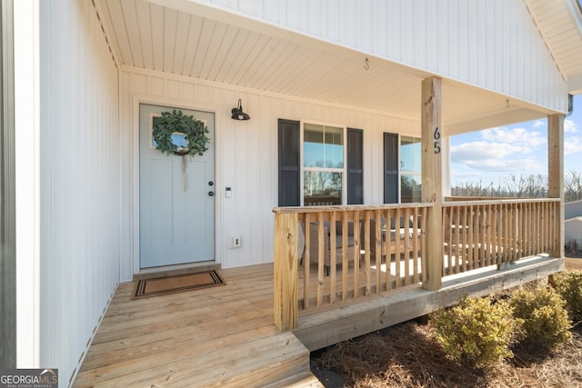 view of exterior entry with a porch