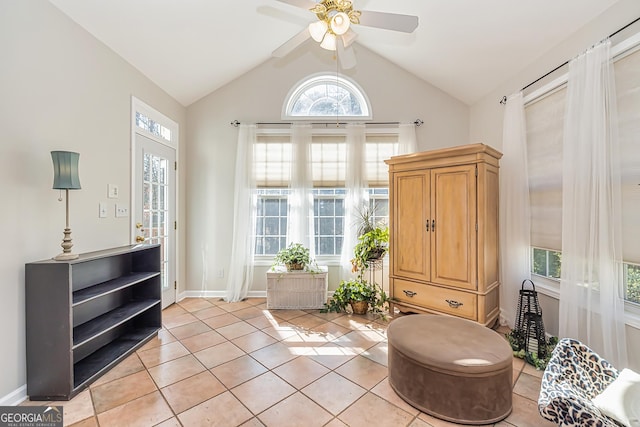 sitting room with ceiling fan, lofted ceiling, plenty of natural light, and light tile patterned floors