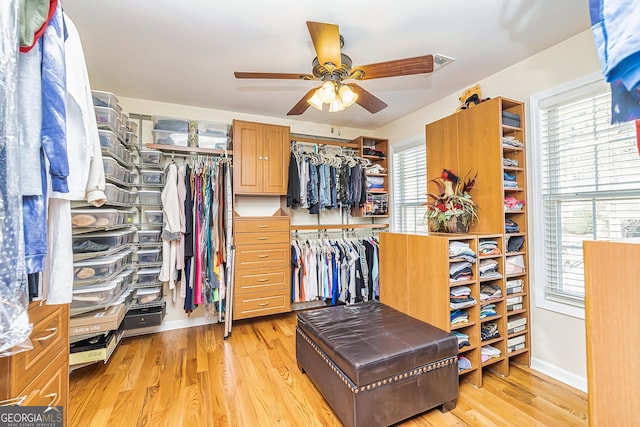 spacious closet with ceiling fan and light hardwood / wood-style flooring