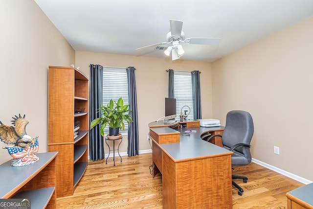 home office featuring ceiling fan and light hardwood / wood-style flooring