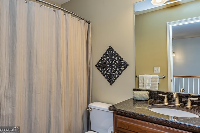 bathroom featuring vanity and toilet