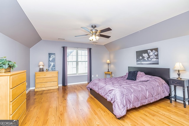 bedroom with hardwood / wood-style flooring, ceiling fan, and lofted ceiling