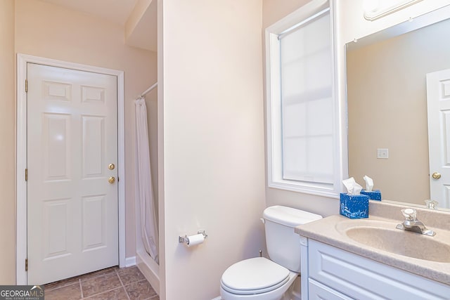 bathroom featuring vanity, a shower with shower curtain, and toilet