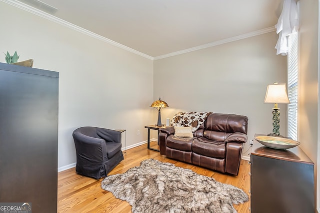 living room featuring ornamental molding and light hardwood / wood-style floors