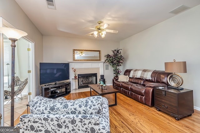 living room with ceiling fan and light hardwood / wood-style flooring