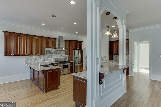 kitchen featuring wall chimney range hood, sink, stainless steel appliances, light hardwood / wood-style floors, and kitchen peninsula