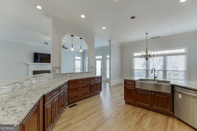 kitchen with sink, decorative light fixtures, ornamental molding, and dishwasher