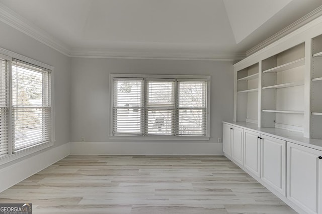 empty room featuring ornamental molding and light hardwood / wood-style floors