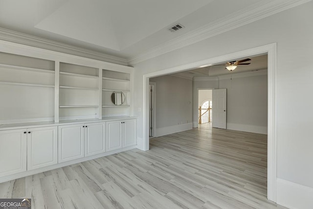 interior space featuring crown molding, ceiling fan, light hardwood / wood-style floors, and a tray ceiling