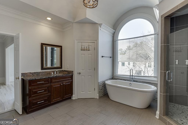 bathroom featuring ornamental molding, vanity, and shower with separate bathtub