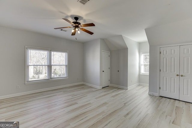 additional living space with ceiling fan and light hardwood / wood-style floors