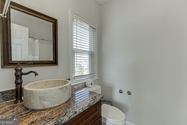 bathroom featuring vanity and toilet